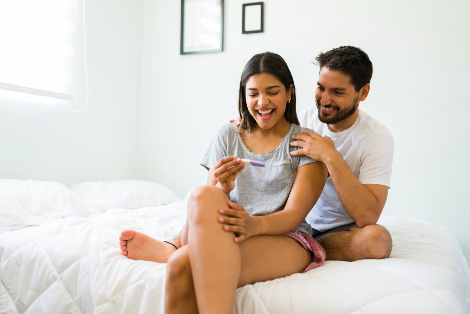 A couple sitting together at home, smiling